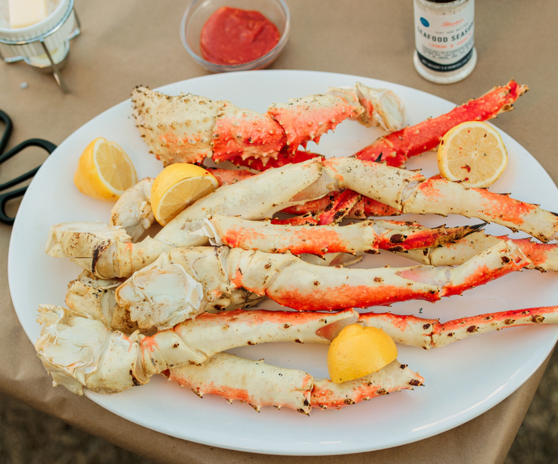 King Crab Legs and Lemon Wedges on a white platter ready for serving