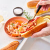 Lobster meat being placed into a lobster roll bun